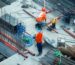 Prefabricated steel warehouse under construction with crane
