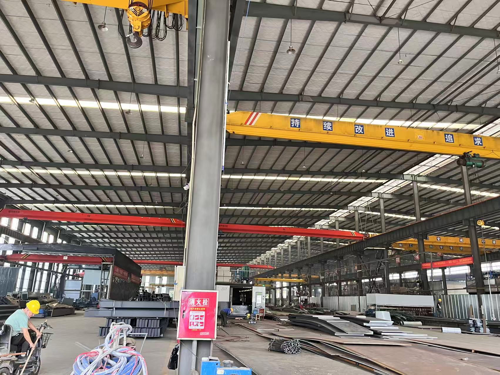 Interior of a steel industrial building with overhead crane and clear-span frame