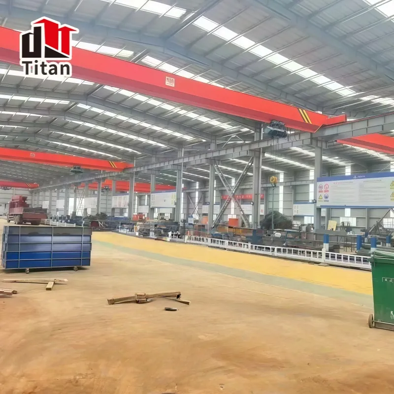 Overhead crane inside a steel workshop building with runway beams