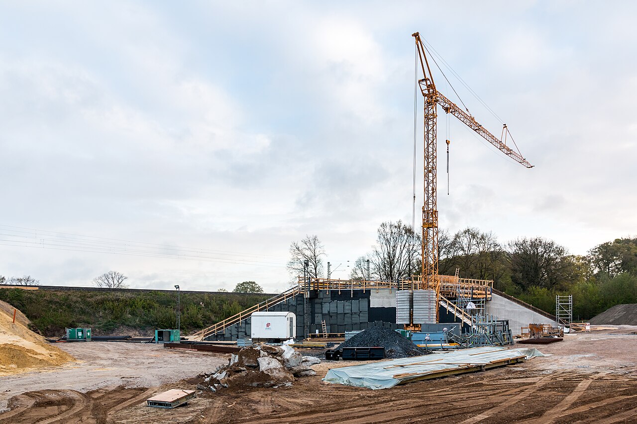 Steel portal frame being erected with a mobile crane