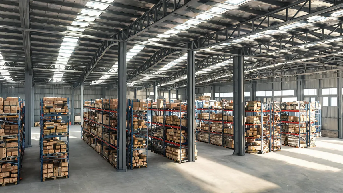 Multi-span steel warehouse interior with interior columns and roof purlins