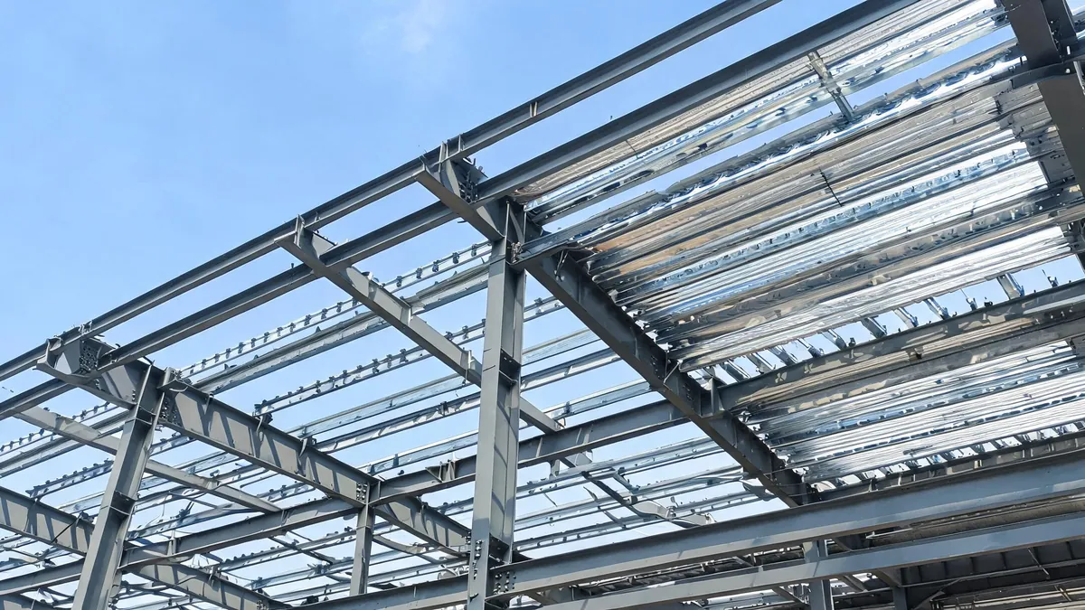 Steel roof purlins and profiled metal roof deck under construction