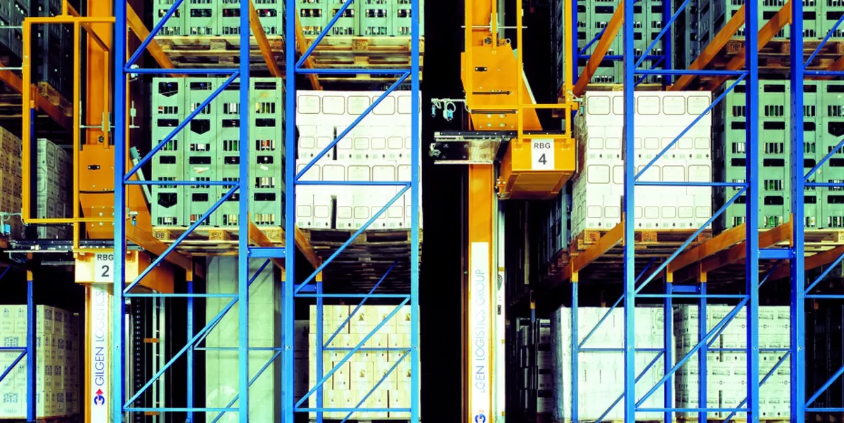 Automated high-bay warehouse interior with racking aisles and stacker cranes