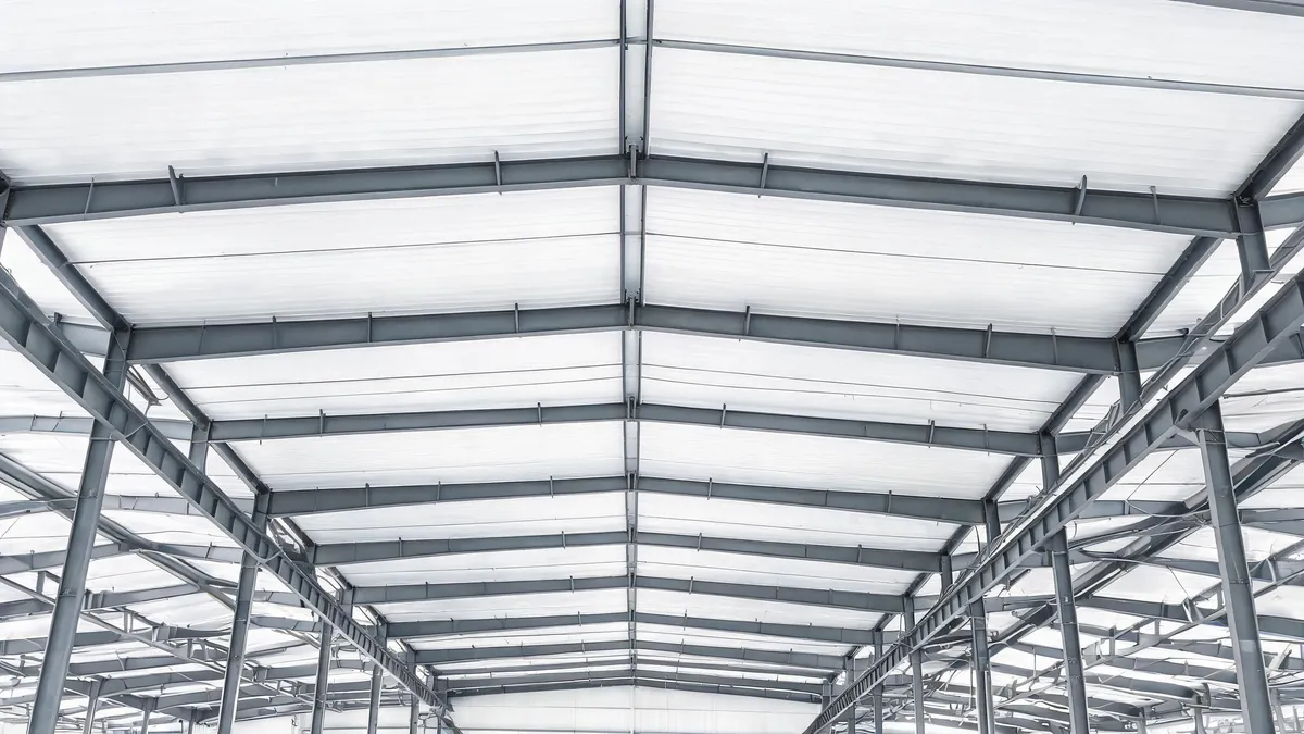 Insulated sandwich panel roof interior of a steel warehouse with clean liner ceiling and purlins