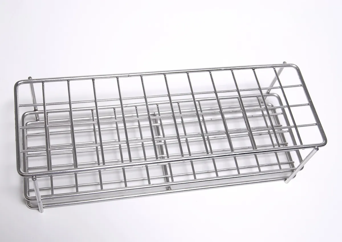 Stacked hollow steel tube sections stored on a rack in a steel workshop